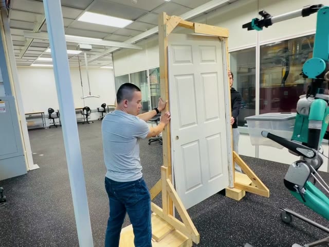 The team tests a door interaction with the humanoid.