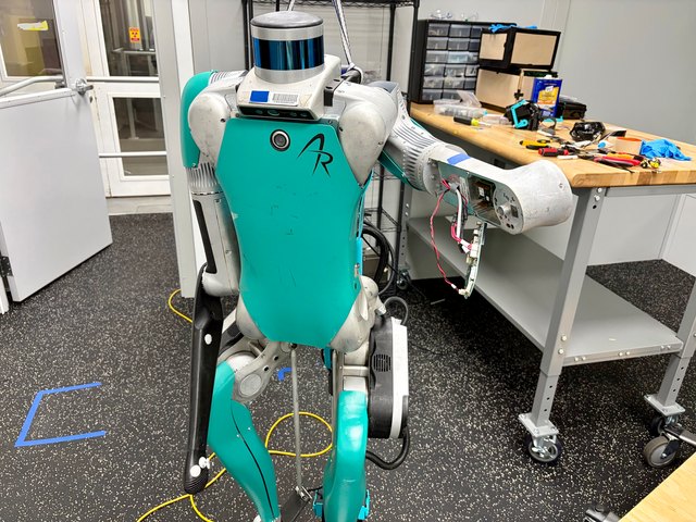 The humanoid left arm opened for repair at the workbench.