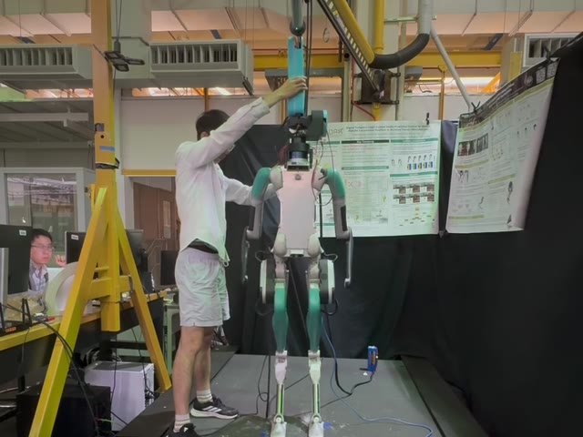 A researcher checks the SRL motion beside the humanoid.